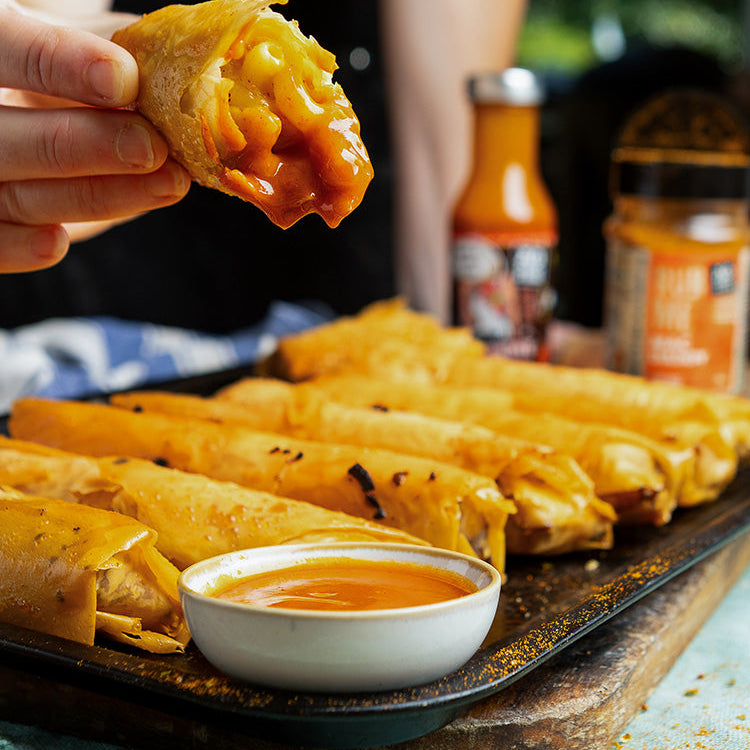 spring rolls stuffed with mac & cheese made using angus & oink Mac Daddy seasoning and buffalo sauce to finish