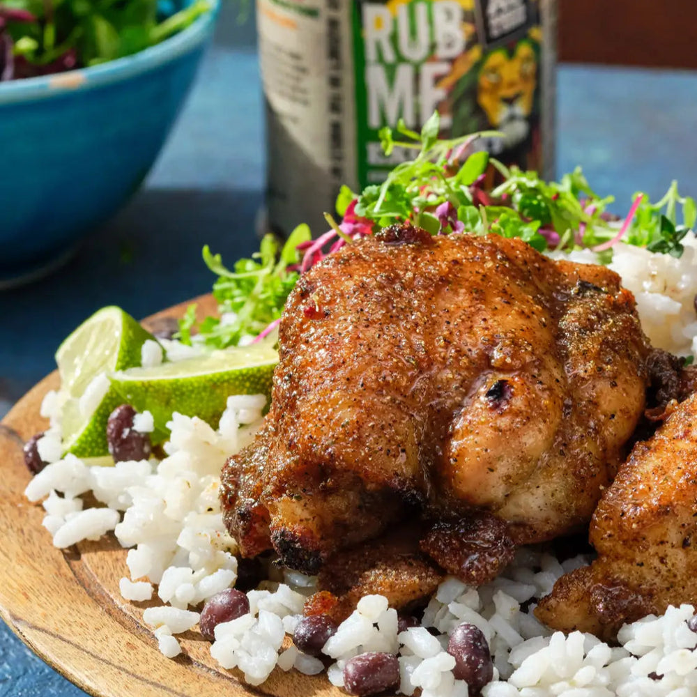 jerk chicken with rice and lime to garnish. chicken seasoned with angus & oink Exodust jerk